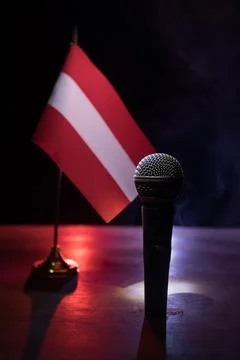 Microphone on a background of a blurry flag of Austria close-up. dark table d Stockfoto's