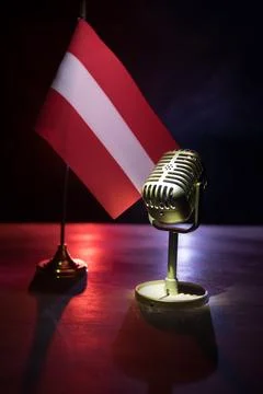Microphone on a background of a blurry flag of Austria close-up. dark table d 写真素材