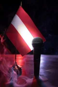 Microphone on a background of a blurry flag of Austria close-up. dark table d 写真素材
