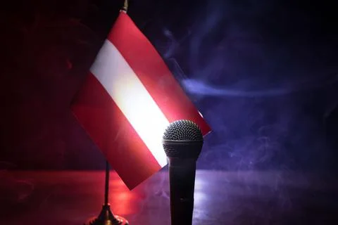 Microphone on a background of a blurry flag of Austria close-up. dark table d 写真素材
