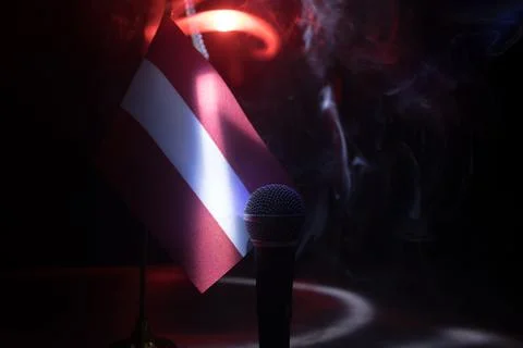 Microphone on a background of a blurry flag of Austria close-up. dark table d Stock-Fotos