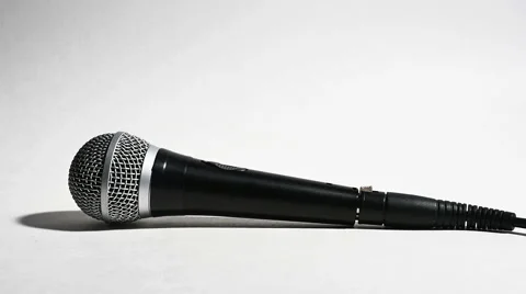 Microphone Being Picked Up by Man Isolated on White in Slow Motion Stock Footage 57171022