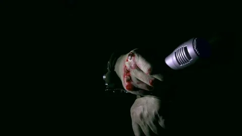 Microphone in a bloody hand handcuffed. Video stock 166940686