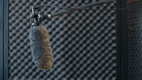 Microphone on boom pole in a studio - copy space Video stock 125475598