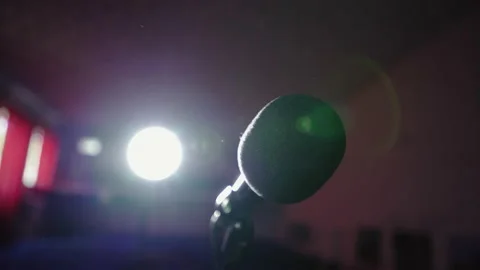 Microphone in bright light. An empty hall without spectators. Concert hall. Видео 140966065