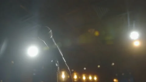 Microphone in bright light. An empty hall without spectators. Concert hall scene Stock Footage 223135975