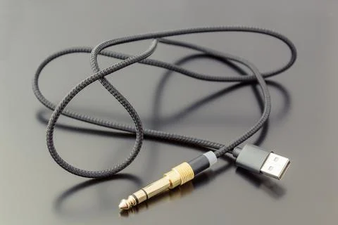 Microphone cable with USB connector, on a dark background. Stock Photos