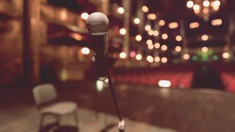 A microphone with a chair in the background Stock Illustration