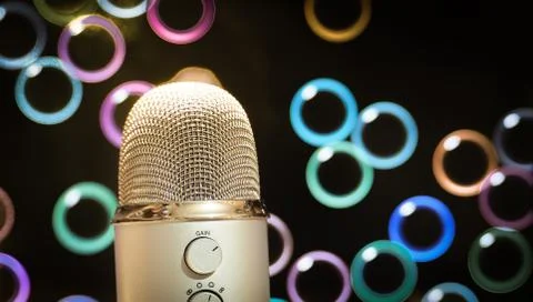 Microphone close up with colorful bubbles background Stock Photos