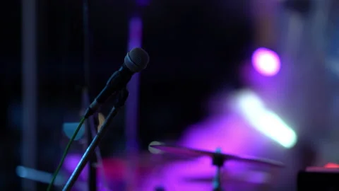 Microphone on colorful light rays on concert stadium Stock Footage 152888966