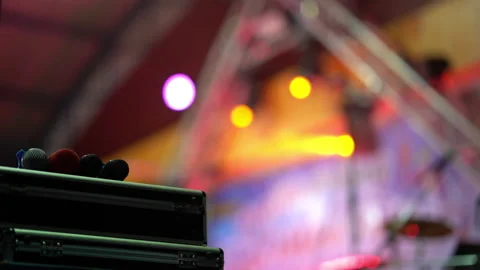 Microphone on colorful light rays on concert stadium Stock Footage 152889254