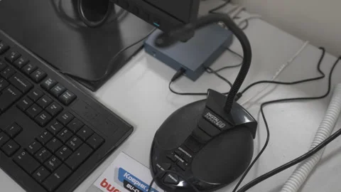 Microphone connected to desktop computer rests on desk Stock Footage 311631859