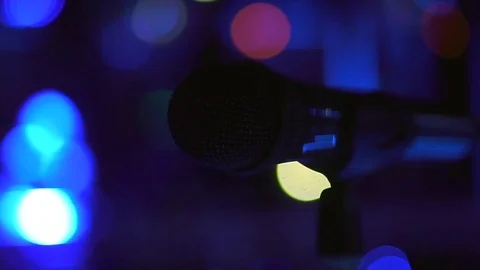 The microphone is on the counter in the darkness on the background of the bokeh Stock Footage 84530367