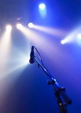 Microphone on empty stage waiting for a voice Stock Photos