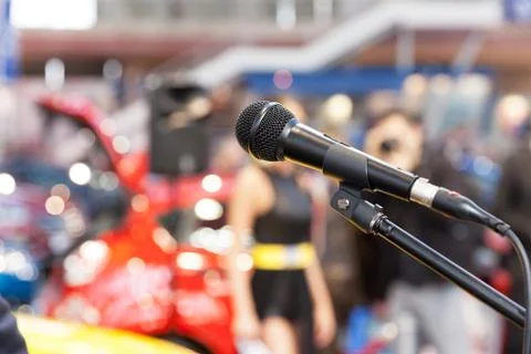Microphone in focus, against blurred background. presentation. Stock Photos