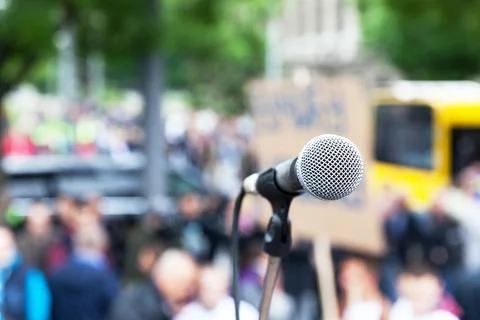 Microphone in focus against blurred protest or public demonstration Stock Photos