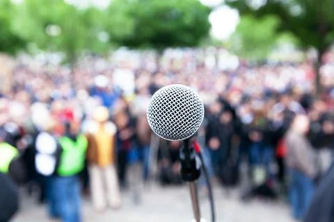 Microphone in focus against blurred protest or public demonstration Stock Photos