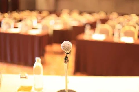 Microphone in front of meeting room empty chairs before the conference Stock Photos