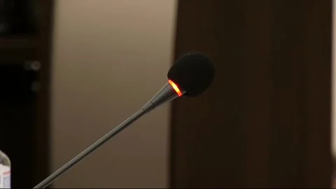 A microphone glows orange against a wall Stock Footage 324766521