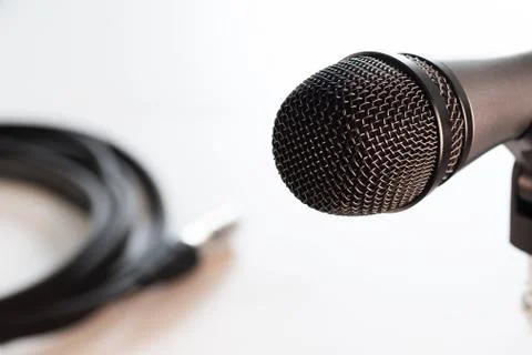 Microphone head closeup and balanced cable in background isolated on white Foto stock