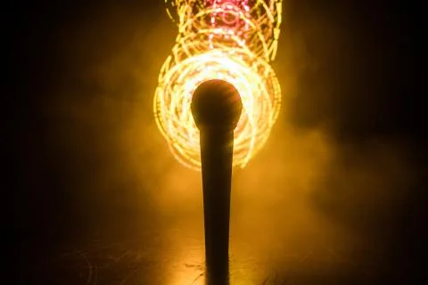 Microphone karaoke, concert . Vocal audio mic in low light with blurred backg Stock Photos