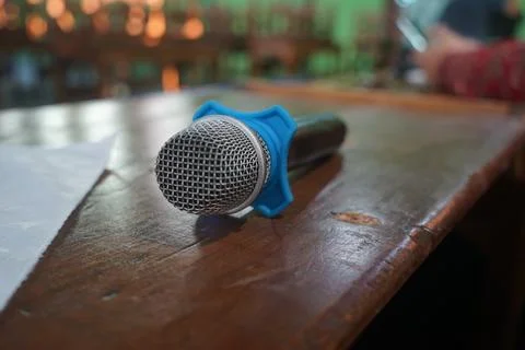 The microphone lies on the table after the presentation is used Stock Photos