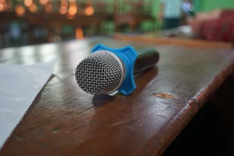 The microphone lies on the table after the presentation is used Stock Photos