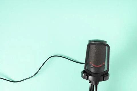Microphone on a light blue background with a space for text. Space for copyin Stock Photos