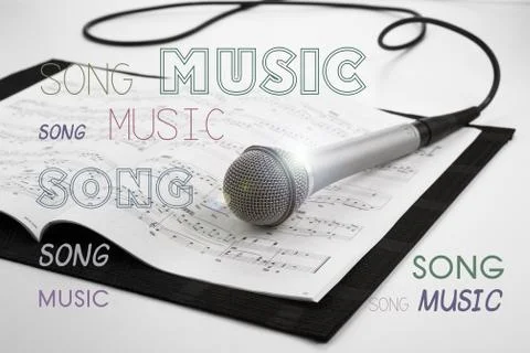 Microphone lying on the musical book Stock Photos