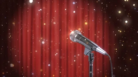 Microphone with Magic Particles against Blurred Red Curtains Background Stock Footage 103822406