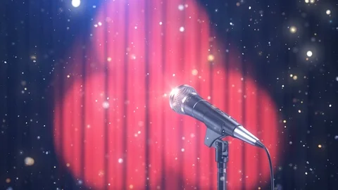 Microphone with Magic Particles against Blurred Red Curtains Video stock 103848388