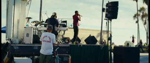 Microphone Performer and Keyboardist on a Sunlit Outdoor Stage Stock Footage 344814966