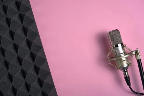 Microphone on pink background with copy space and acoustic foam panel Stock Photos