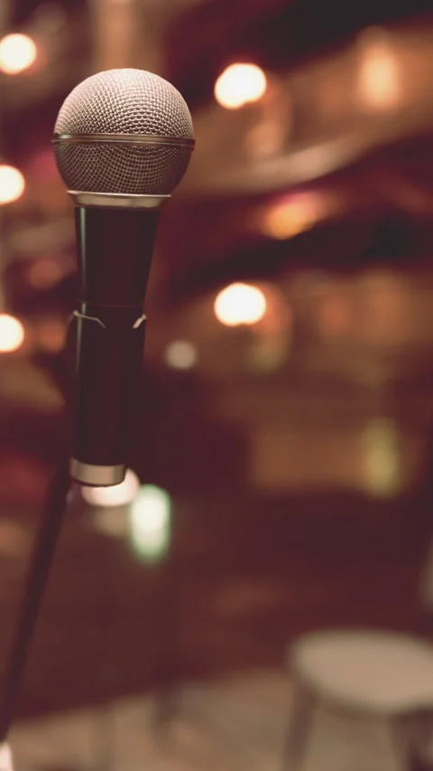 Microphone ready for performance in a setting with soft lighting Stock Footage 340879044