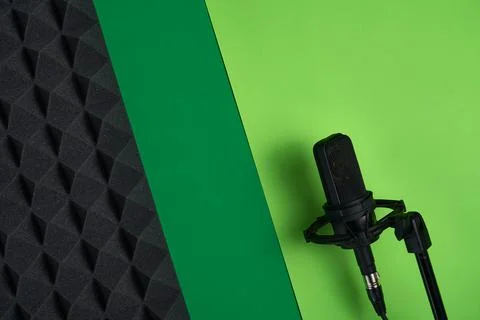 Microphone on red background with copy space and acoustic foam panel Stock Photos