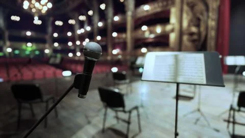 A microphone with a sheet of music in the background Stock Illustration