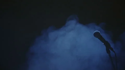 Microphone silhouette on dark stage Stock Footage 92546754