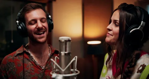 Microphone, singing and couple in studio with headphones for recording music Stock Footage 332322625