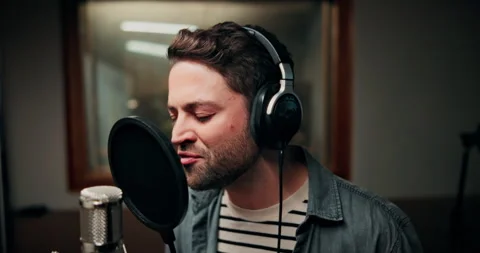 Microphone, singing and man in studio with headphones for recording music with Stock Footage 332322506
