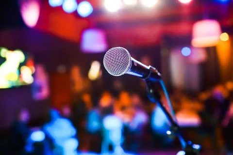 Microphone on stage against a background of auditorium. Stock Photos
