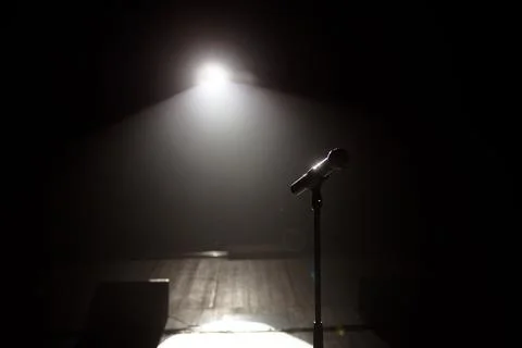 Microphone on the stage with black background Stock Photos