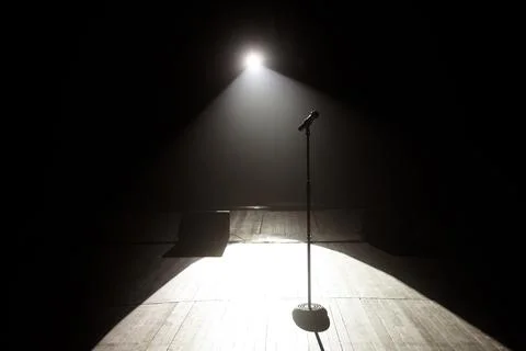 Microphone on the stage with black background Stock Photos