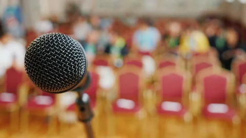 Microphone on stage with blurred audience in background ready for a live ev.. Stock Footage 334704578