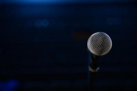 Microphone on stage on a blurry background from a close angle Stock Photos
