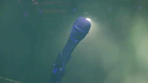 Microphone on the stage with bokeh light effects. Movement Stock Footage