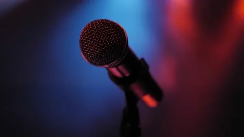 Microphone on stage in the dark on the background of multicolored lights. Stock Footage 157413272
