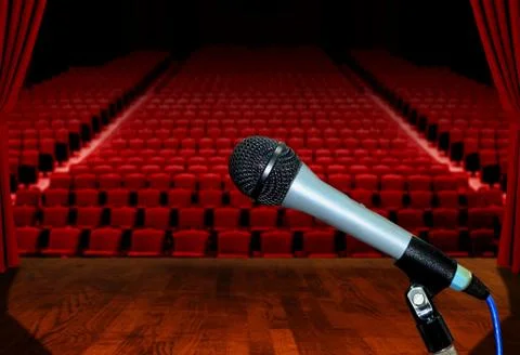 Microphone on stage facing empty auditorium seats Stock Photos