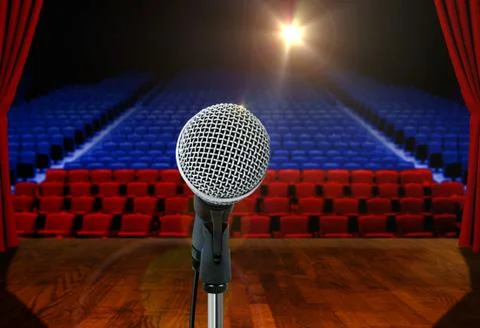 Microphone on stage facing empty seats Stock Photos
