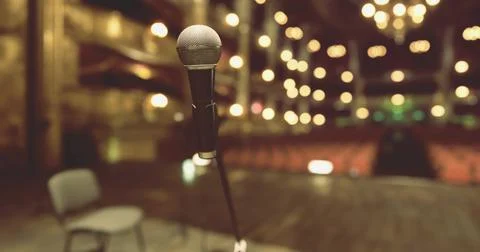 Microphone on stage ready for performance at a theater during evening Stock Illustration