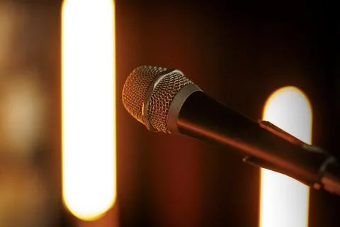 Microphone on Stage with Warm Backlighting Stock Photos